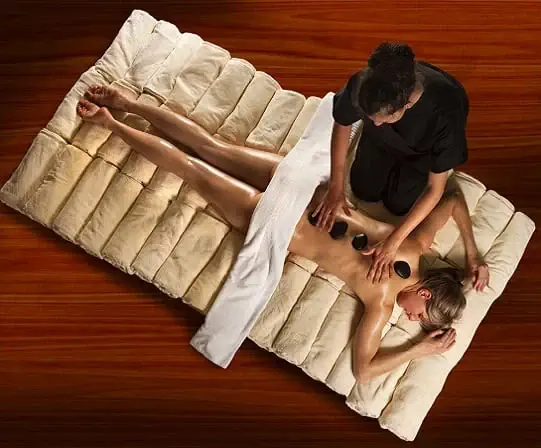 person enjoying massage with stones - Hotel Roc Blanc