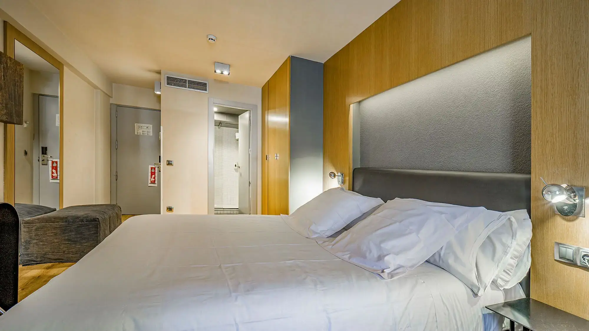 double room with double bed decoratedin grey and wood - standard room- roc blanc hotel & spa andorra