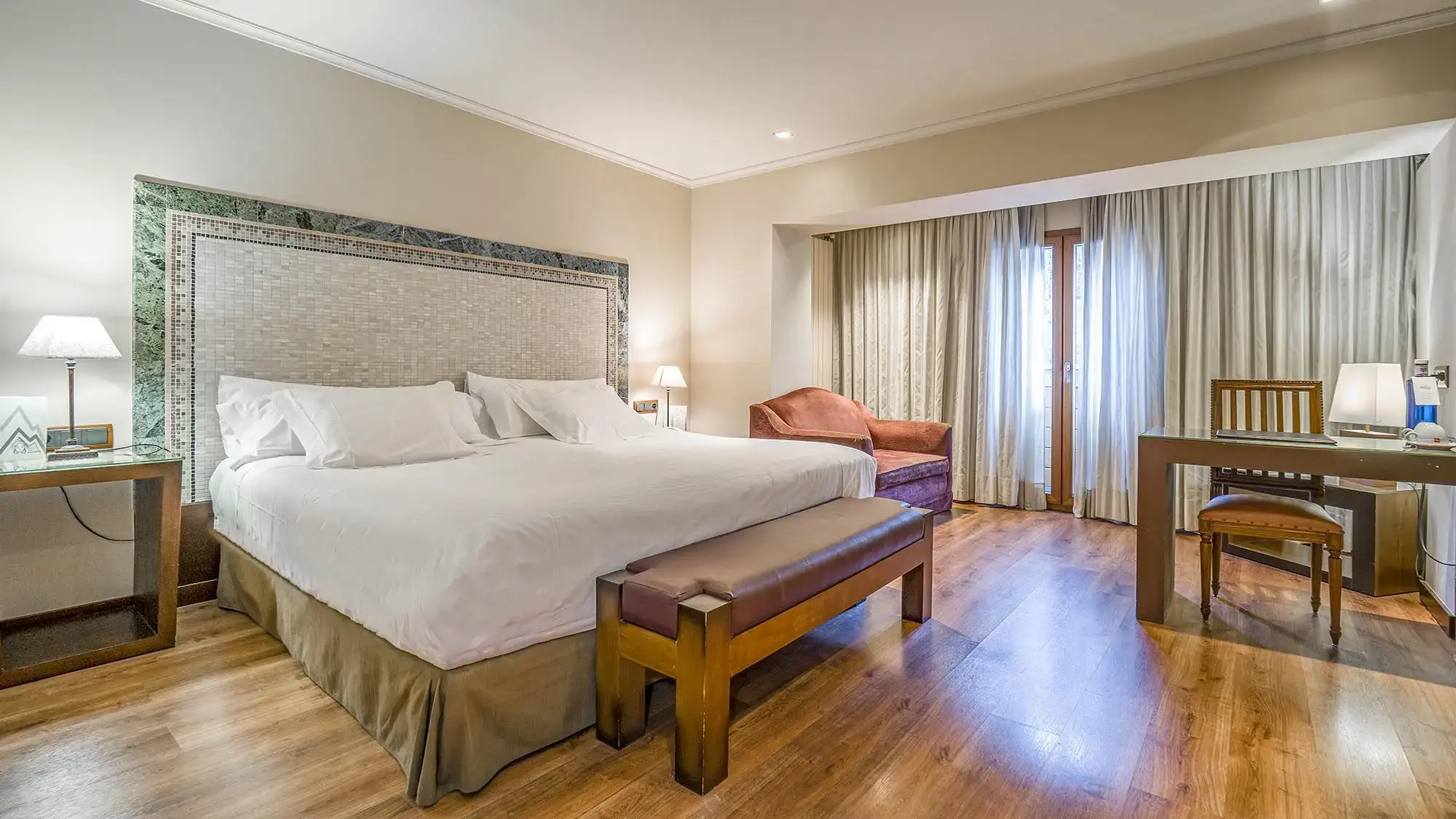 double room with double bed, sitting area and small desk - deluxe room- roc blanc hotel & spa andorra